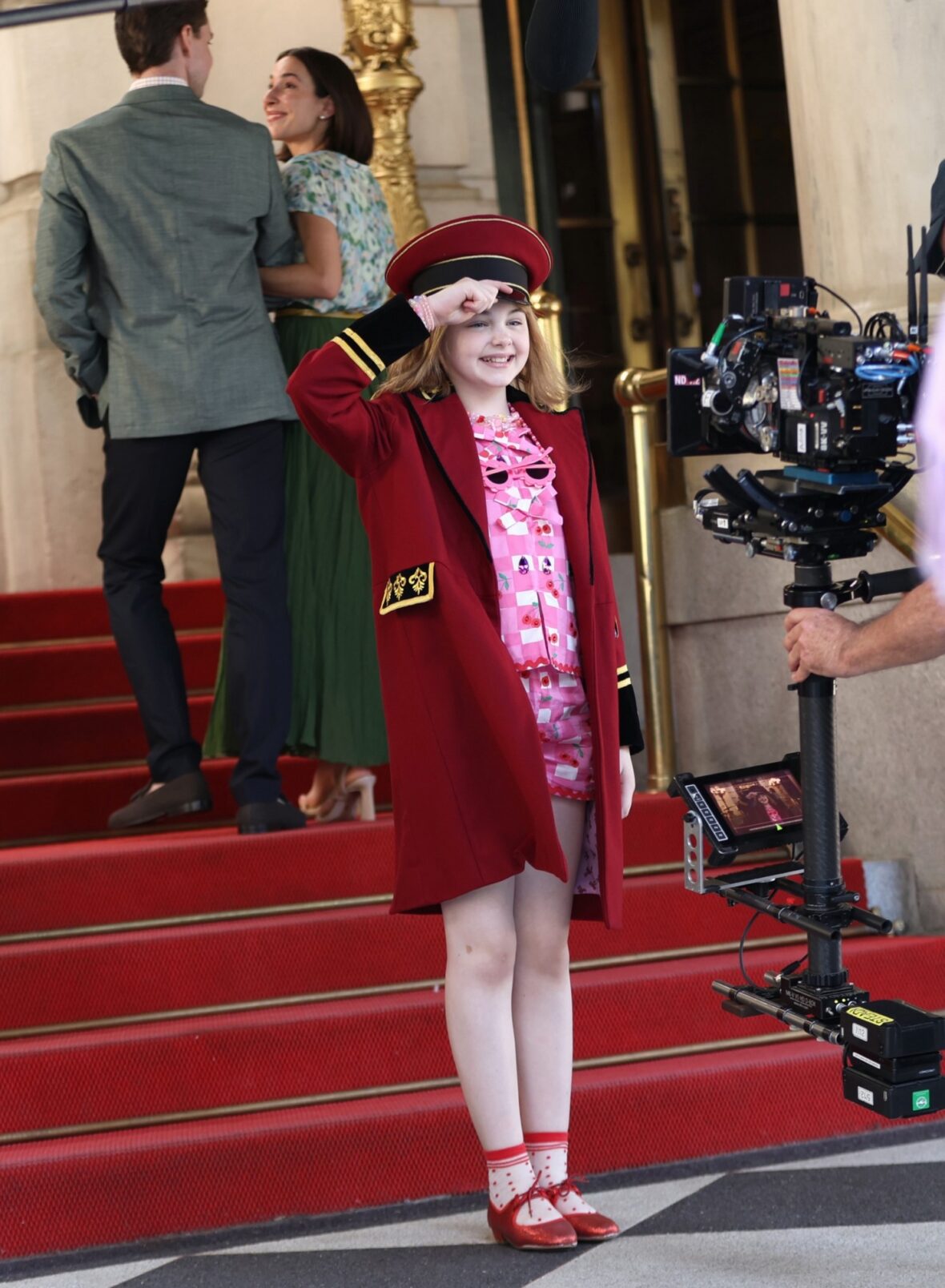 Mae Schenk wears a red ensemble to film scenes outside the Plaza Hotel for ELOISE