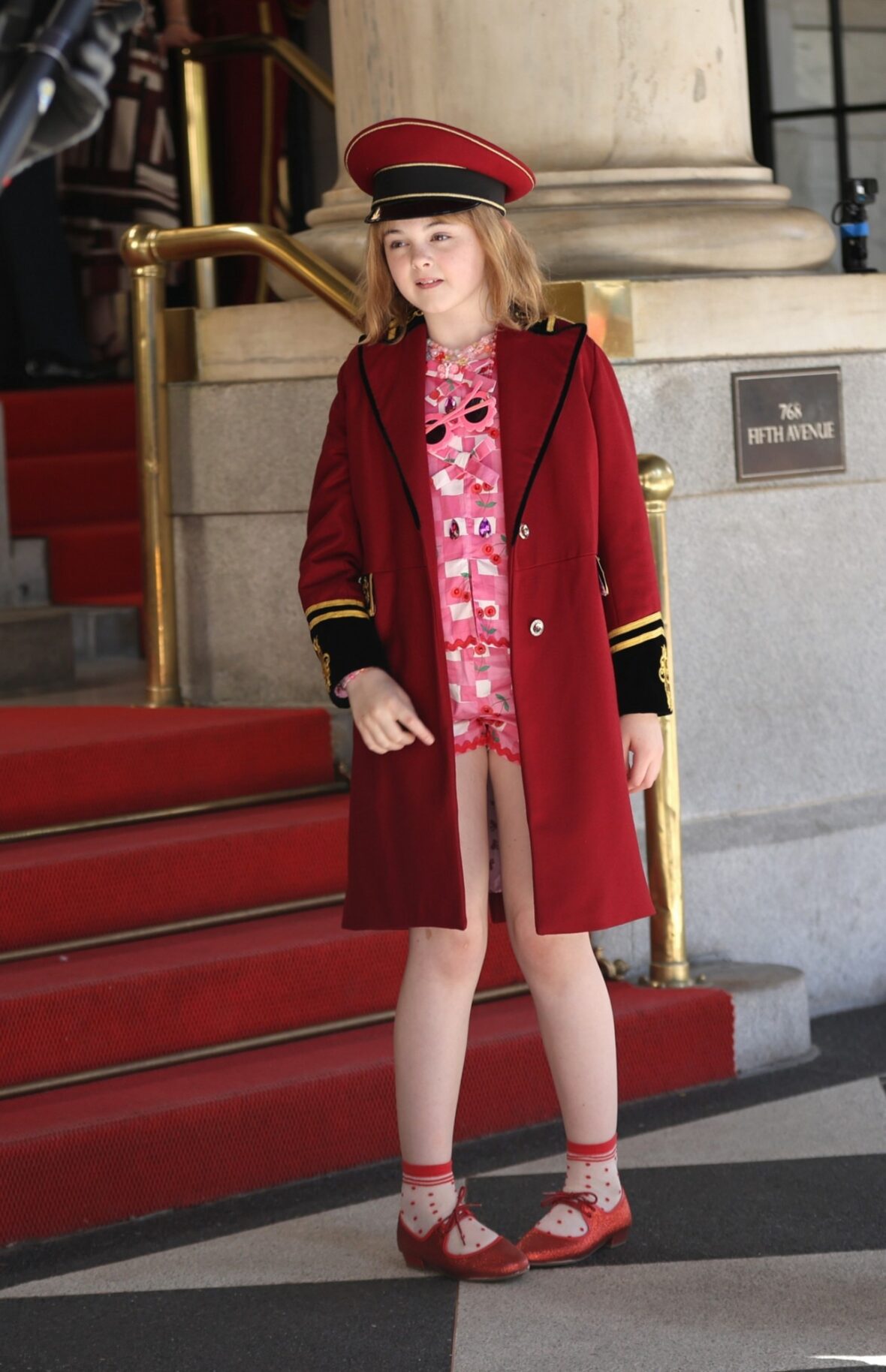 Mae Schenk wears a red ensemble to film scenes outside the Plaza Hotel for ELOISE