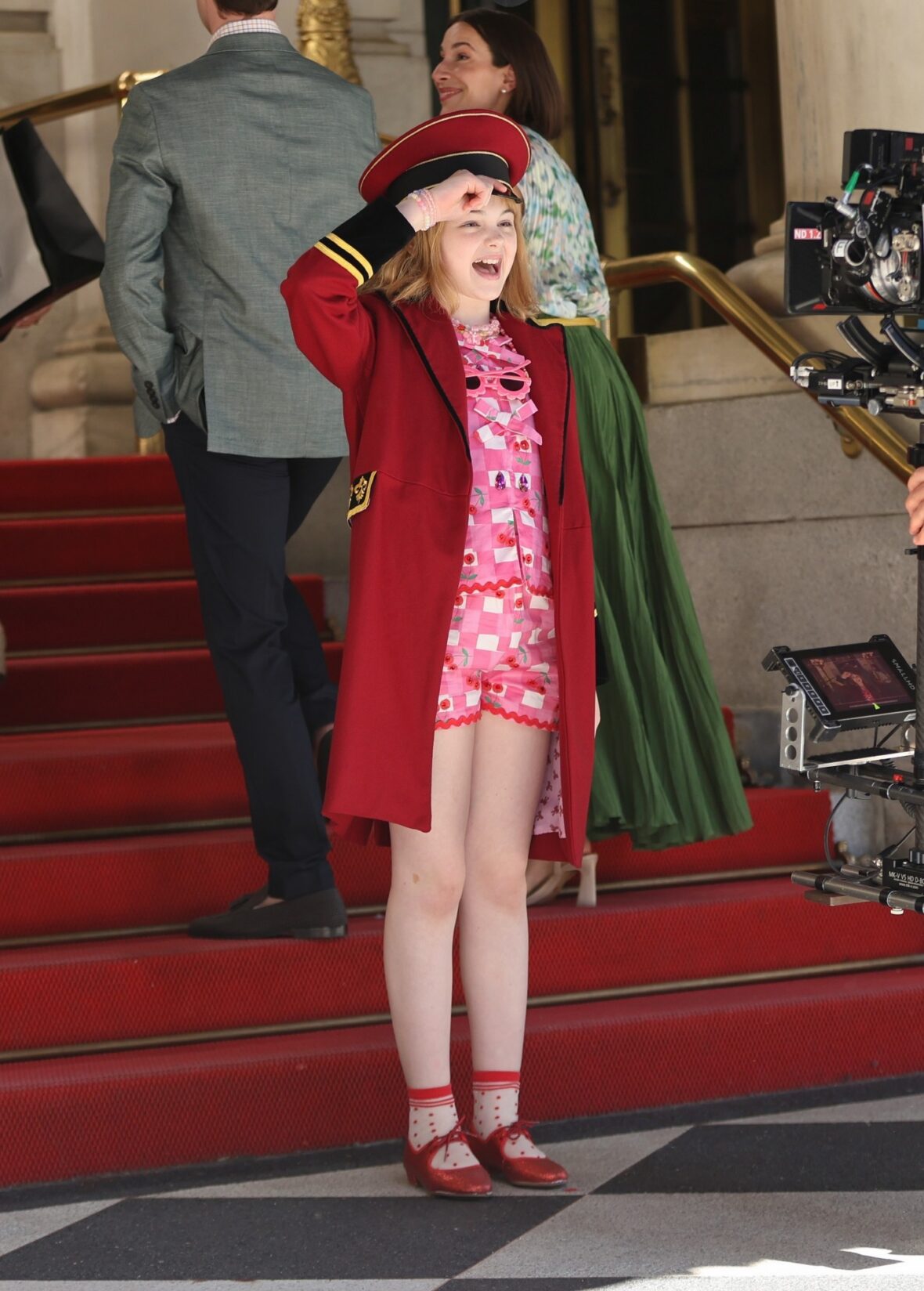 Mae Schenk wears a red ensemble to film scenes outside the Plaza Hotel for ELOISE
